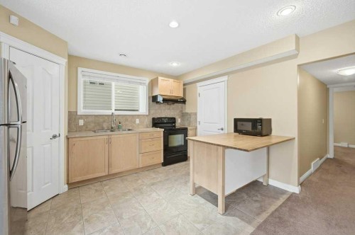 101 Panamount Manor Nw, Calgary, AB - Indoor Photo Showing Kitchen With Double Sink