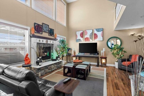 935 Bayside Drive Sw, Airdrie, AB - Indoor Photo Showing Living Room With Fireplace