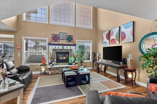 935 Bayside Drive Sw, Airdrie, AB - Indoor Photo Showing Living Room With Fireplace