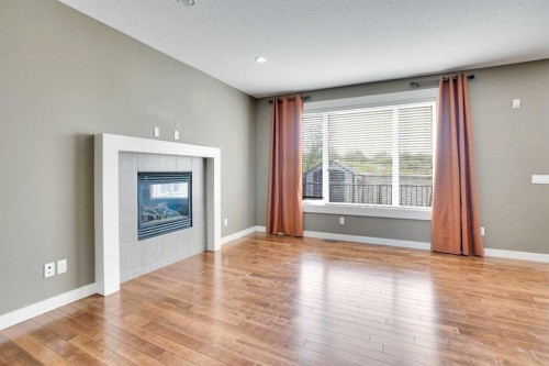 157 Rainbow Falls Boulevard, Chestermere, AB - Indoor Photo Showing Other Room With Fireplace