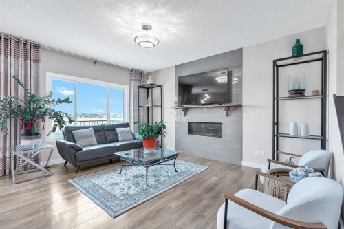 304 Corner Meadows Manor Ne, Calgary, AB - Indoor Photo Showing Living Room With Fireplace