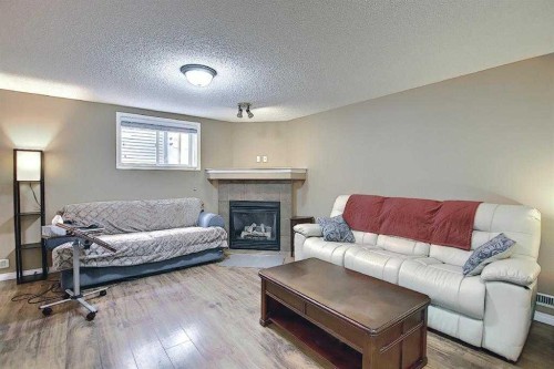 1 Prestwick Mount Se, Calgary, AB - Indoor Photo Showing Living Room With Fireplace
