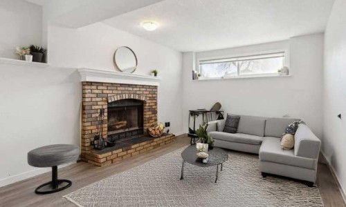 36 Riverview Drive, Cochrane, AB - Indoor Photo Showing Living Room With Fireplace