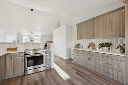 36 Riverview Drive, Cochrane, AB - Indoor Photo Showing Kitchen With Upgraded Kitchen