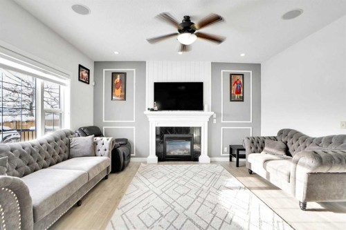 85 Saddlebrook Circle Ne, Calgary, AB - Indoor Photo Showing Living Room With Fireplace