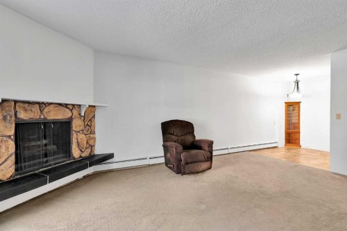 2106-4001B 49 Street Nw, Calgary, AB - Indoor Photo Showing Living Room With Fireplace