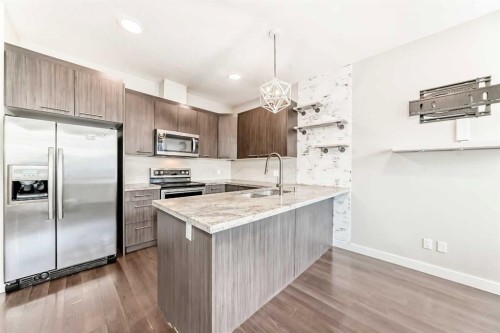115-300 Marina Drive, Chestermere, AB - Indoor Photo Showing Kitchen With Stainless Steel Kitchen With Upgraded Kitchen