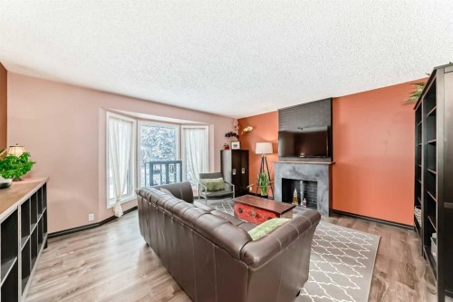238 Berwick Drive Nw, Calgary, AB - Indoor Photo Showing Living Room With Fireplace