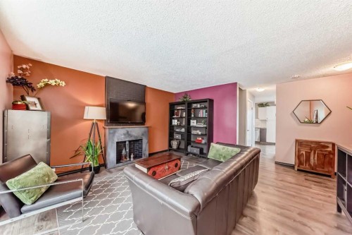 238 Berwick Drive Nw, Calgary, AB - Indoor Photo Showing Living Room With Fireplace