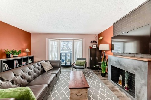 238 Berwick Drive Nw, Calgary, AB - Indoor Photo Showing Living Room With Fireplace