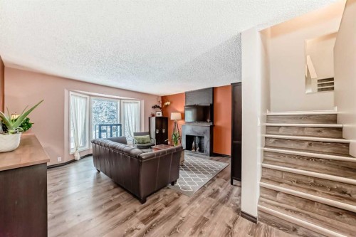 238 Berwick Drive Nw, Calgary, AB - Indoor Photo Showing Living Room With Fireplace