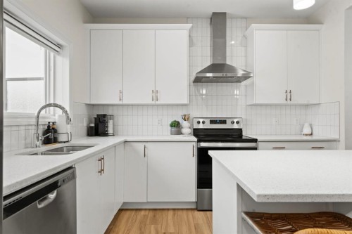 10 Emberside Link, Cochrane, AB - Indoor Photo Showing Kitchen With Stainless Steel Kitchen With Double Sink