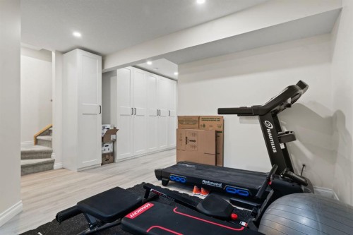 10 Emberside Link, Cochrane, AB - Indoor Photo Showing Gym Room