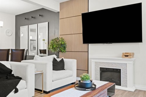 10 Emberside Link, Cochrane, AB - Indoor Photo Showing Living Room With Fireplace