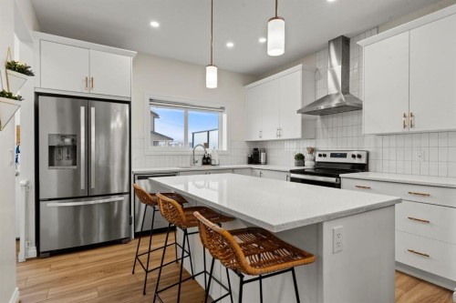 10 Emberside Link, Cochrane, AB - Indoor Photo Showing Kitchen With Stainless Steel Kitchen With Upgraded Kitchen
