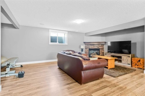 811 Boulder Creek Drive Se, Langdon, AB - Indoor Photo Showing Living Room With Fireplace