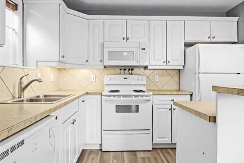 102-139 26 Avenue Nw, Calgary, AB - Indoor Photo Showing Kitchen With Double Sink