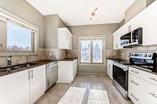 12 Cougar Ridge Landing Sw, Calgary, AB - Indoor Photo Showing Kitchen With Double Sink