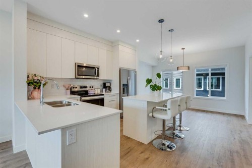 302-6 Merganser Drive, Chestermere, AB - Indoor Photo Showing Kitchen With Stainless Steel Kitchen With Double Sink With Upgraded Kitchen