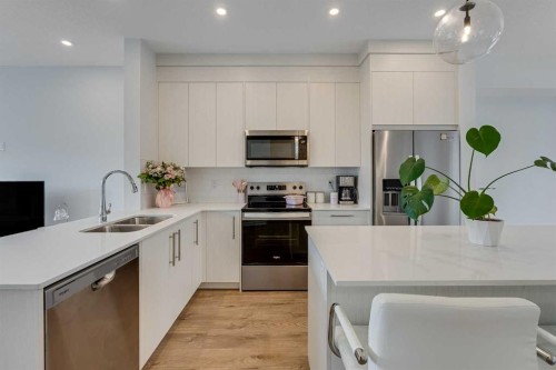 302-6 Merganser Drive, Chestermere, AB - Indoor Photo Showing Kitchen With Stainless Steel Kitchen With Double Sink With Upgraded Kitchen
