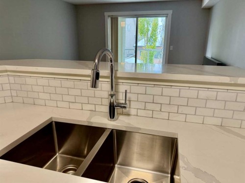 1212-2518 Fish Creek Boulevard Sw, Calgary, AB - Indoor Photo Showing Kitchen With Double Sink