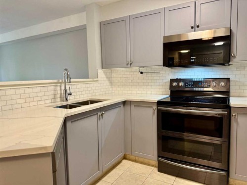 1212-2518 Fish Creek Boulevard Sw, Calgary, AB - Indoor Photo Showing Kitchen With Double Sink