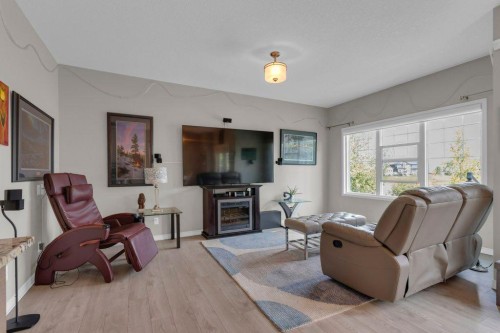 138 Reunion Landing, Airdrie, AB - Indoor Photo Showing Living Room With Fireplace