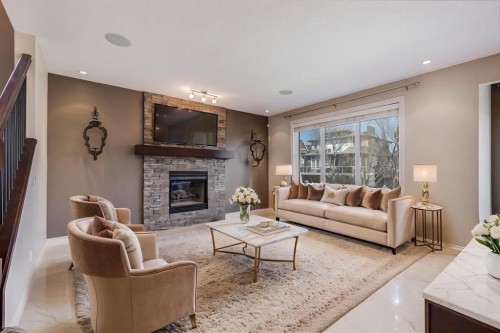 202 Cooperstown Lane Sw, Airdrie, AB - Indoor Photo Showing Living Room With Fireplace