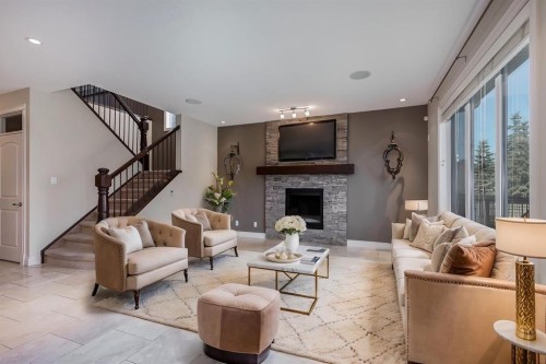 202 Cooperstown Lane Sw, Airdrie, AB - Indoor Photo Showing Living Room With Fireplace