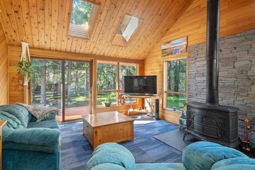 9 Ghost Road, Benchlands, AB - Indoor Photo Showing Living Room With Fireplace