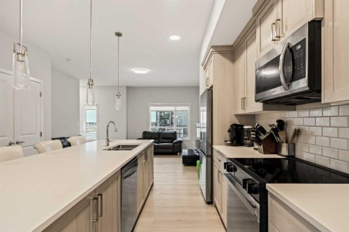 611-20295 Seton Way Se, Calgary, AB - Indoor Photo Showing Kitchen With Double Sink With Upgraded Kitchen