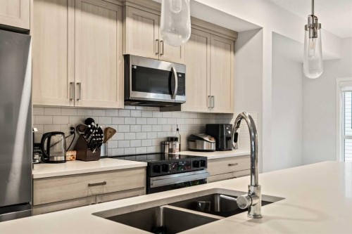 611-20295 Seton Way Se, Calgary, AB - Indoor Photo Showing Kitchen With Stainless Steel Kitchen With Double Sink With Upgraded Kitchen