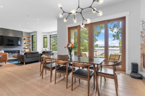 732 West Chestermere Drive, Chestermere, AB - Indoor Photo Showing Dining Room With Fireplace