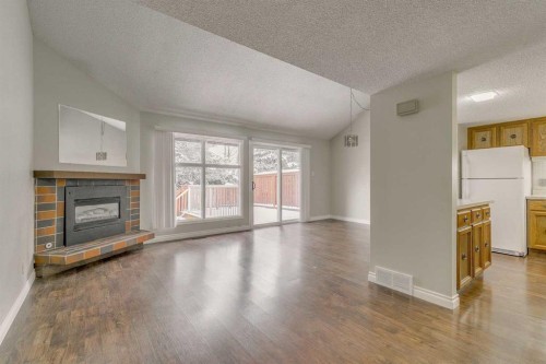 9-2225 Oakmoor Drive Sw, Calgary, AB - Indoor Photo Showing Living Room With Fireplace