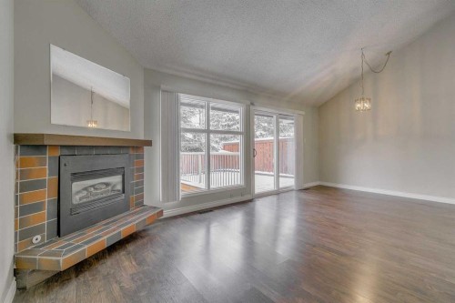 9-2225 Oakmoor Drive Sw, Calgary, AB - Indoor Photo Showing Living Room With Fireplace