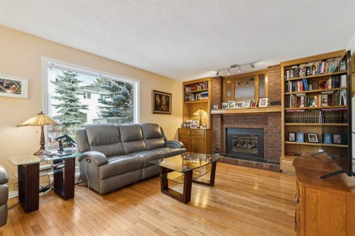 181 Woodford Drive Sw, Calgary, AB - Indoor Photo Showing Living Room With Fireplace
