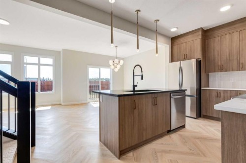 86 Agate Road, Cochrane, AB - Indoor Photo Showing Kitchen With Upgraded Kitchen