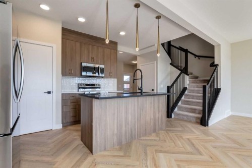 86 Agate Road, Cochrane, AB - Indoor Photo Showing Kitchen With Upgraded Kitchen