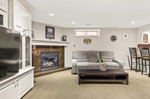 25 Mckinley Bay Se, Calgary, AB - Indoor With Fireplace