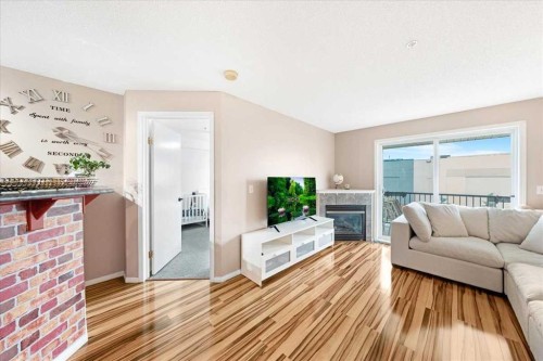 4214-4975 130 Avenue Se, Calgary, AB - Indoor Photo Showing Living Room With Fireplace