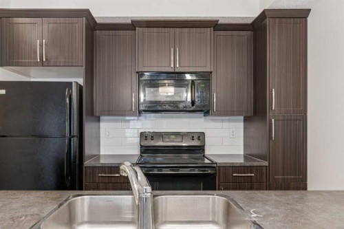 9211-101 Sunset Drive, Cochrane, AB - Indoor Photo Showing Kitchen With Double Sink