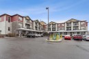 9211-101 Sunset Drive, Cochrane, AB  - Outdoor With Balcony With Facade 