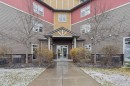 9211-101 Sunset Drive, Cochrane, AB  - Outdoor With Deck Patio Veranda With Facade 
