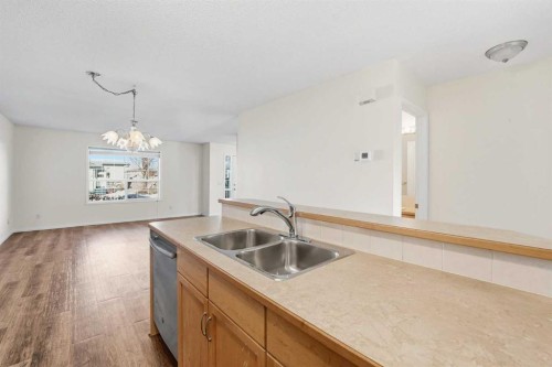 21-33 Stonegate Drive Nw, Airdrie, AB - Indoor Photo Showing Kitchen With Double Sink