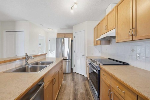21-33 Stonegate Drive Nw, Airdrie, AB - Indoor Photo Showing Kitchen With Double Sink