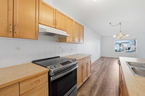 21-33 Stonegate Drive Nw, Airdrie, AB - Indoor Photo Showing Kitchen With Double Sink