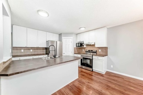 340 Morningside Crescent Sw, Airdrie, AB - Indoor Photo Showing Kitchen With Double Sink