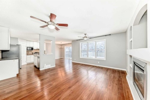 340 Morningside Crescent Sw, Airdrie, AB - Indoor Photo Showing Kitchen With Fireplace
