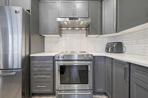 9 Osborne Link, Airdrie, AB - Indoor Photo Showing Kitchen With Stainless Steel Kitchen With Upgraded Kitchen