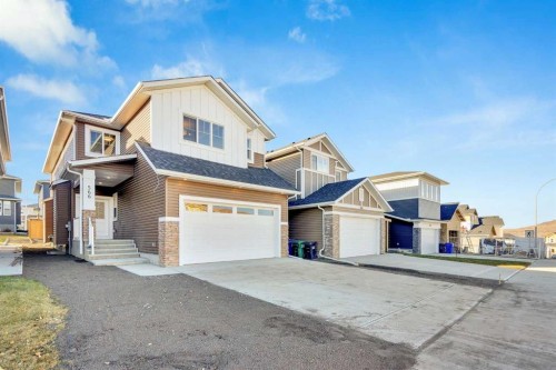 566 Rivercrest View, Cochrane, AB - Outdoor With Facade